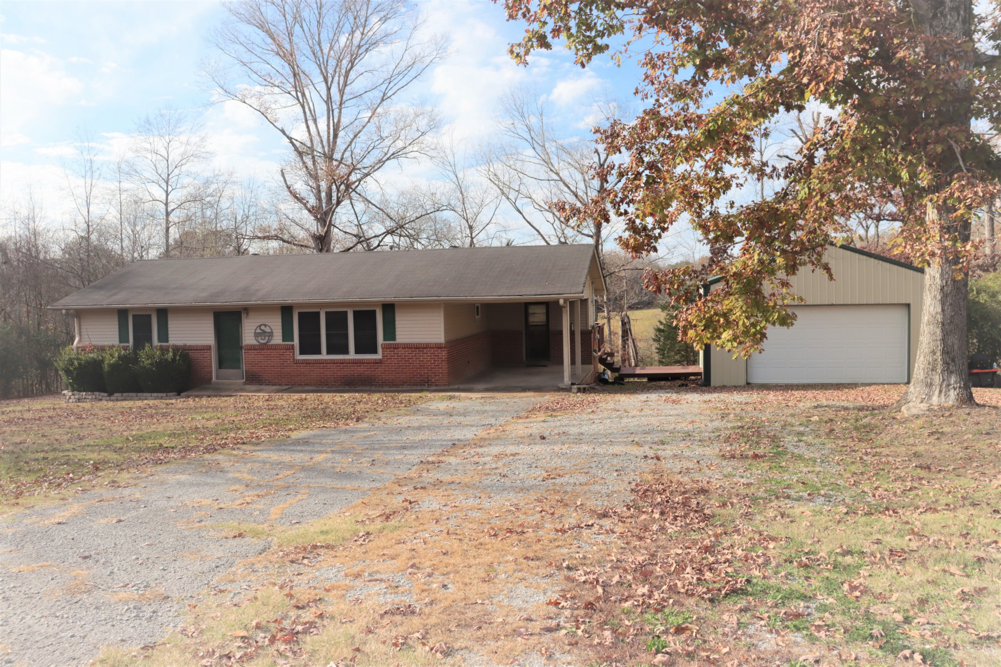 176 Pine Street Parsons, TN 38363 - Photo 2 of 32 a front view of a house with a yard and garage