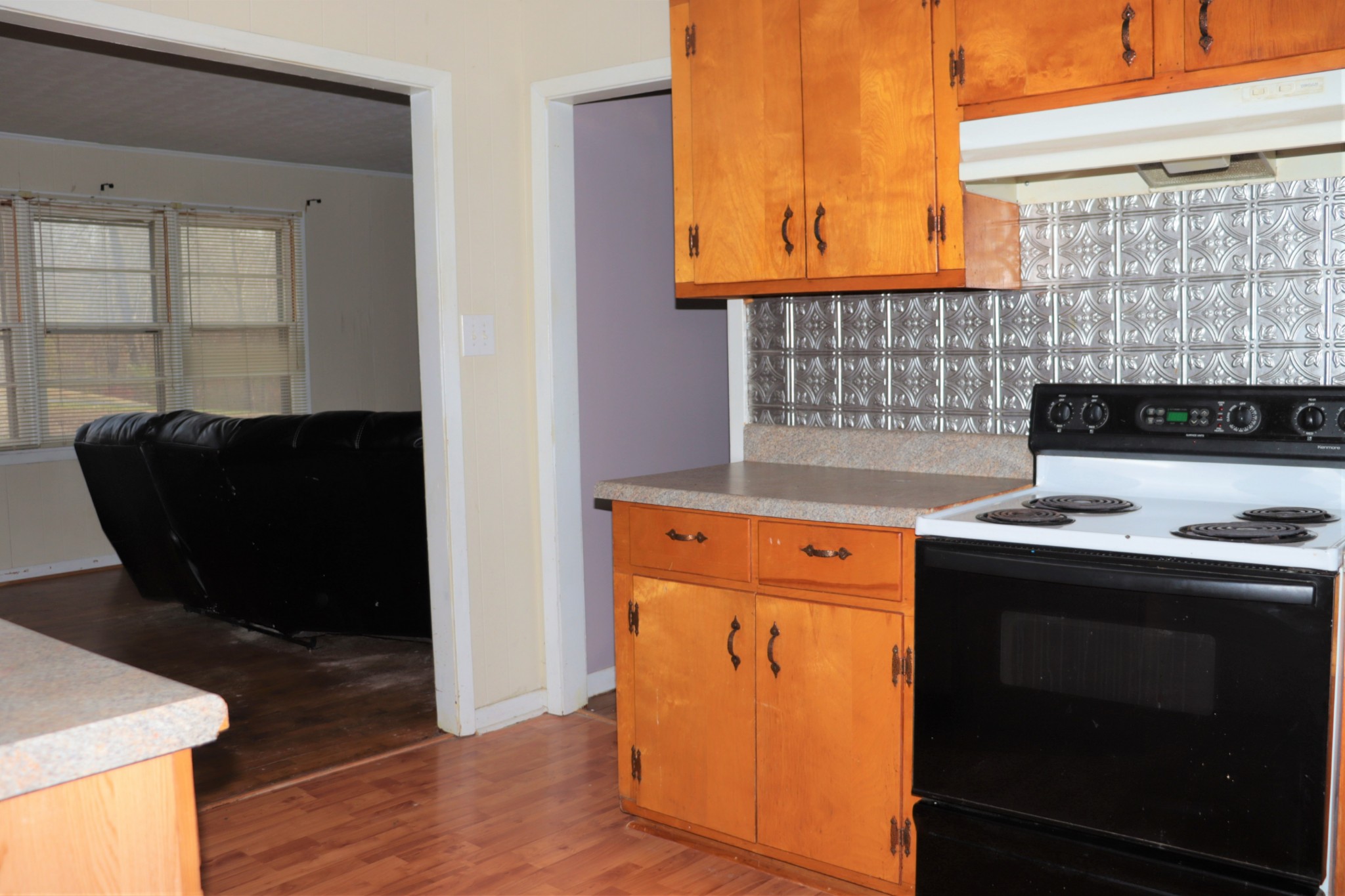 176 Pine Street Parsons, TN 38363 - Photo 7 of 32 a kitchen with a stove and a cabinet
