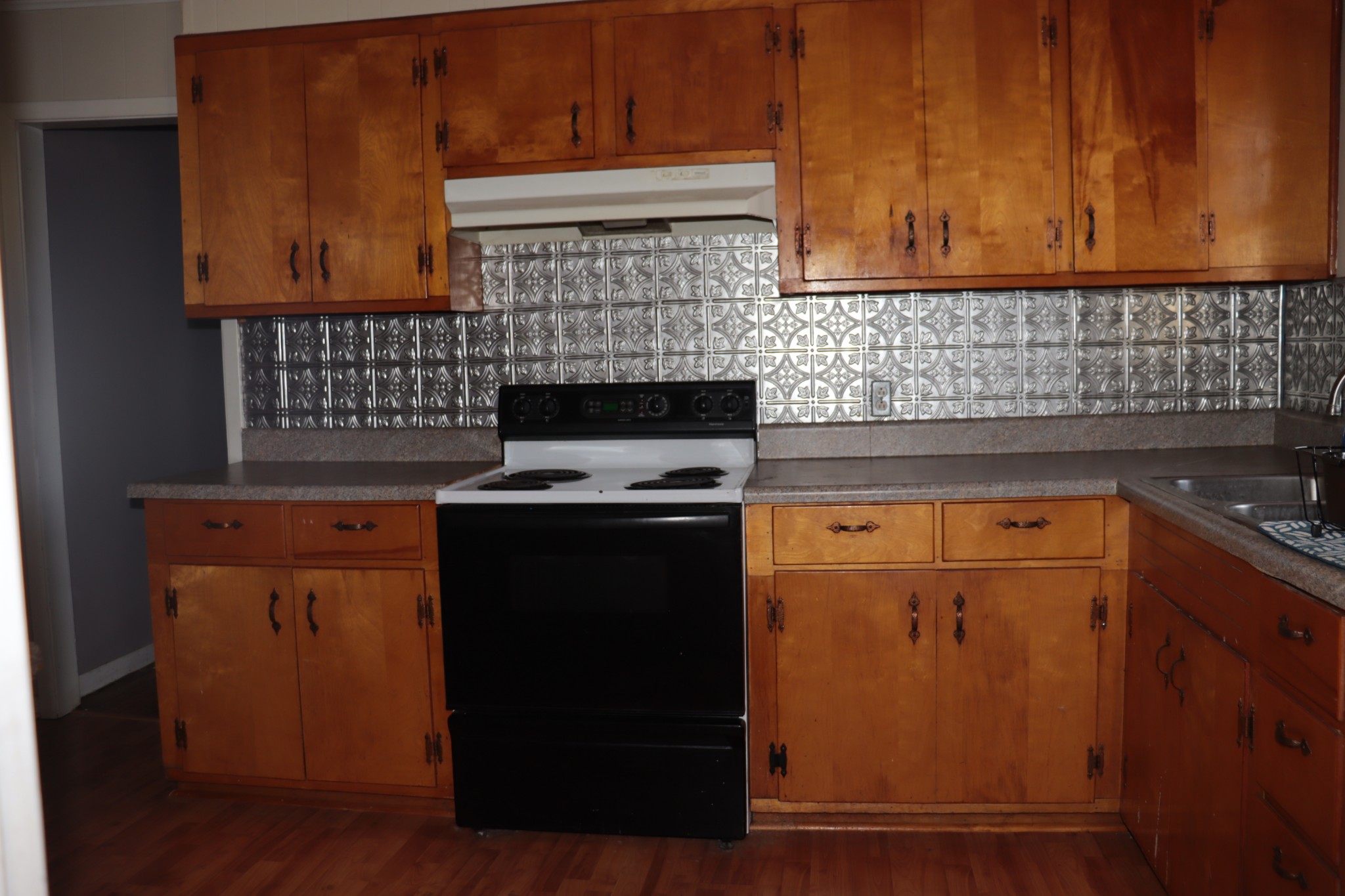 176 Pine Street Parsons, TN 38363 - Photo 10 of 32 a kitchen with granite countertop cabinets and black appliances