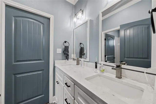a bathroom with 2 sink and a mirror