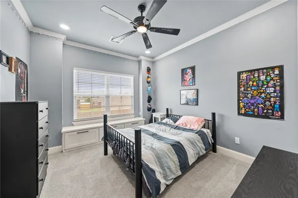 a bedroom with a bed dresser and a window