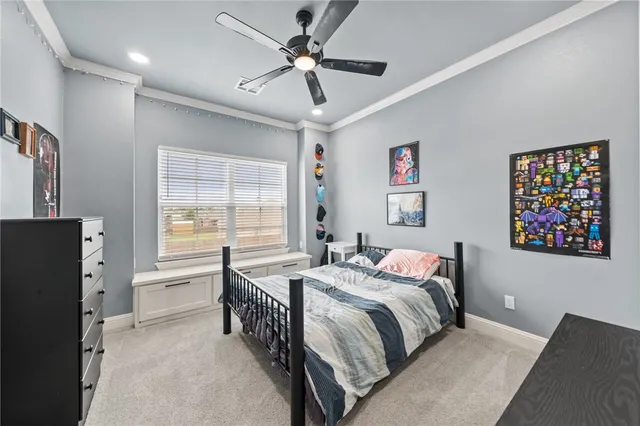 a bedroom with a bed dresser and a window