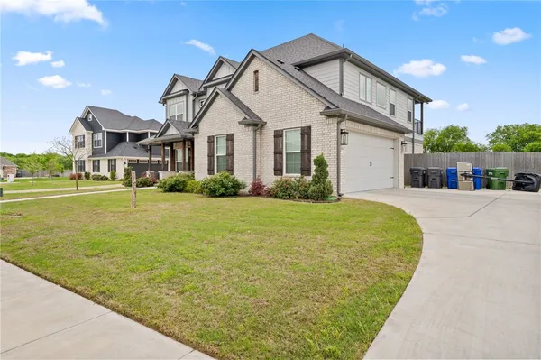 a front view of a house with a garden