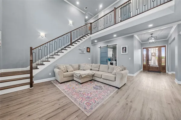 a living room with furniture and wooden floor