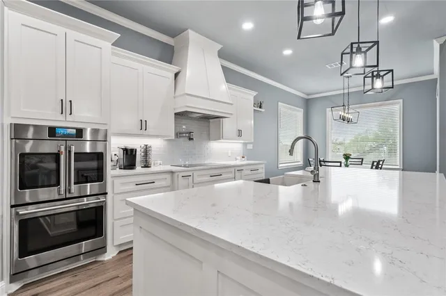 a kitchen with kitchen island a large counter and appliances