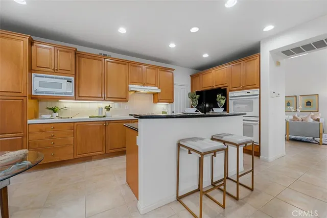 a kitchen with granite countertop a sink and cabinets