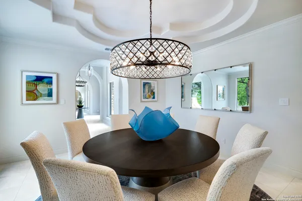a kitchen with granite countertop a table and chairs