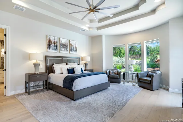 a spacious bathroom with a granite countertop sink mirror and a shower