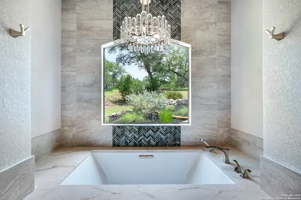 a bathroom with a granite countertop sink and a large mirror