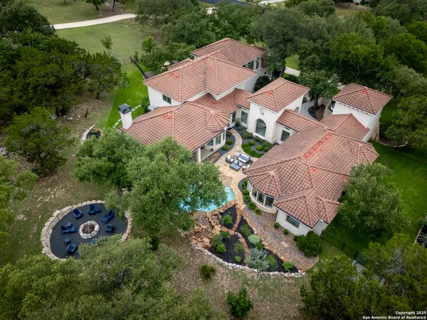 an aerial view of a house with a yard