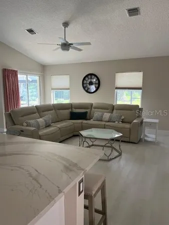 a bedroom with a bed a couch and a large window