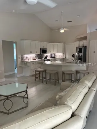 a bathroom with a double vanity sink mirror and bathtub