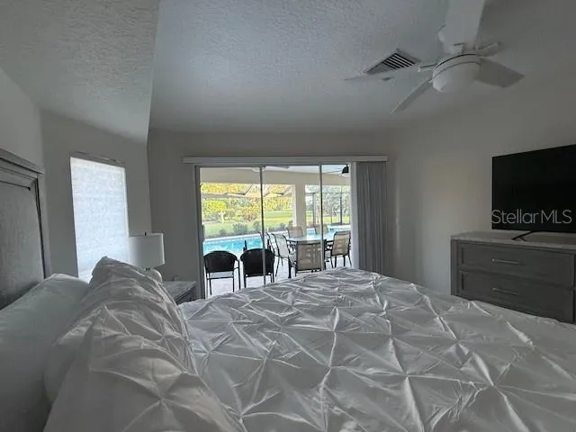 a view of an empty room with a fireplace and a window