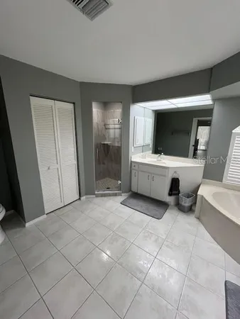 a bedroom with a bed and a ceiling fan