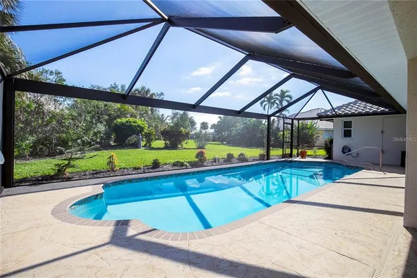 a kitchen with stainless steel appliances kitchen island granite countertop a refrigerator and a stove top oven