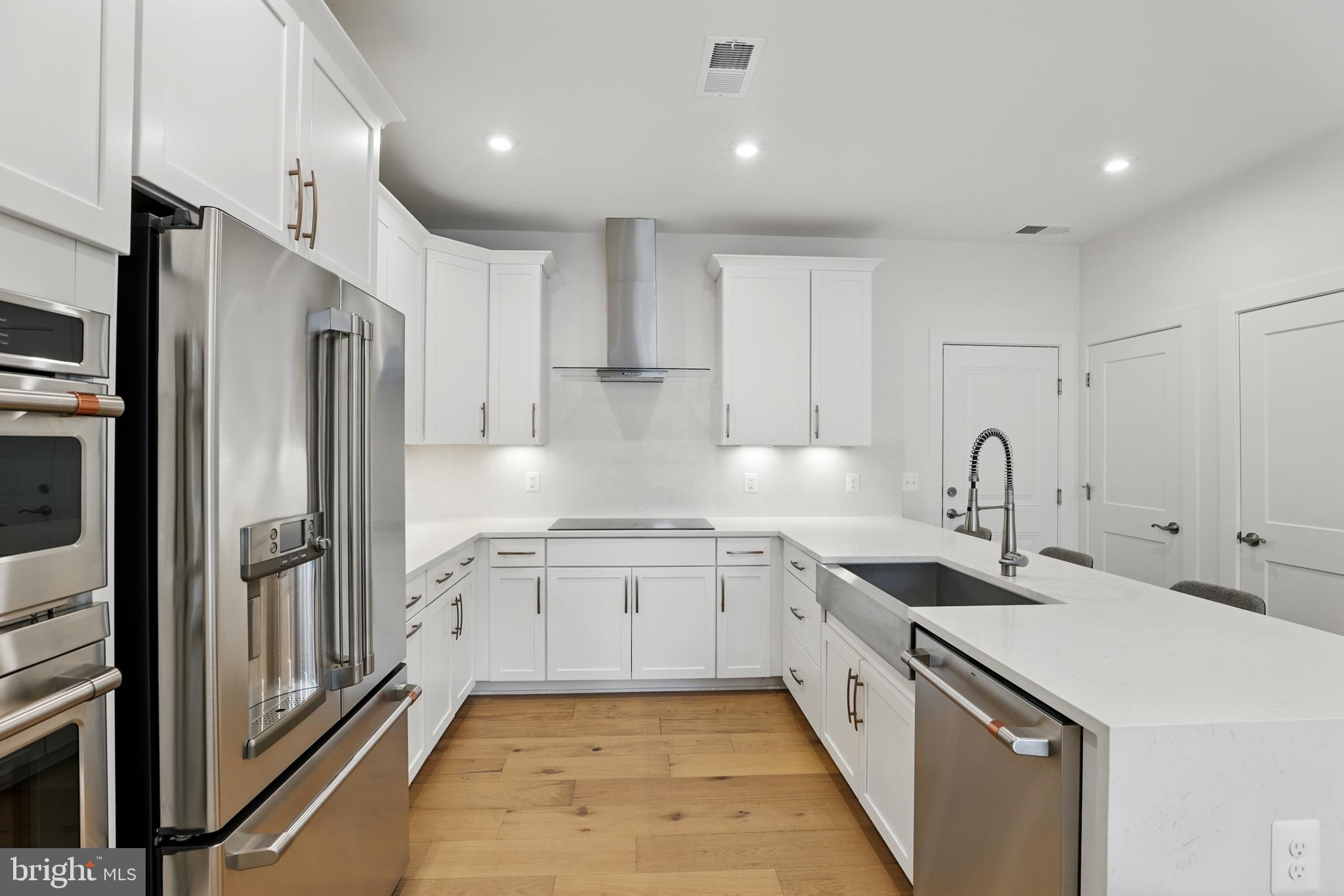4140 Legato Road, Unit 47 Fairfax, VA 22033 - Photo 7 of 23 a large kitchen with stainless steel appliances granite countertop a sink and cabinets