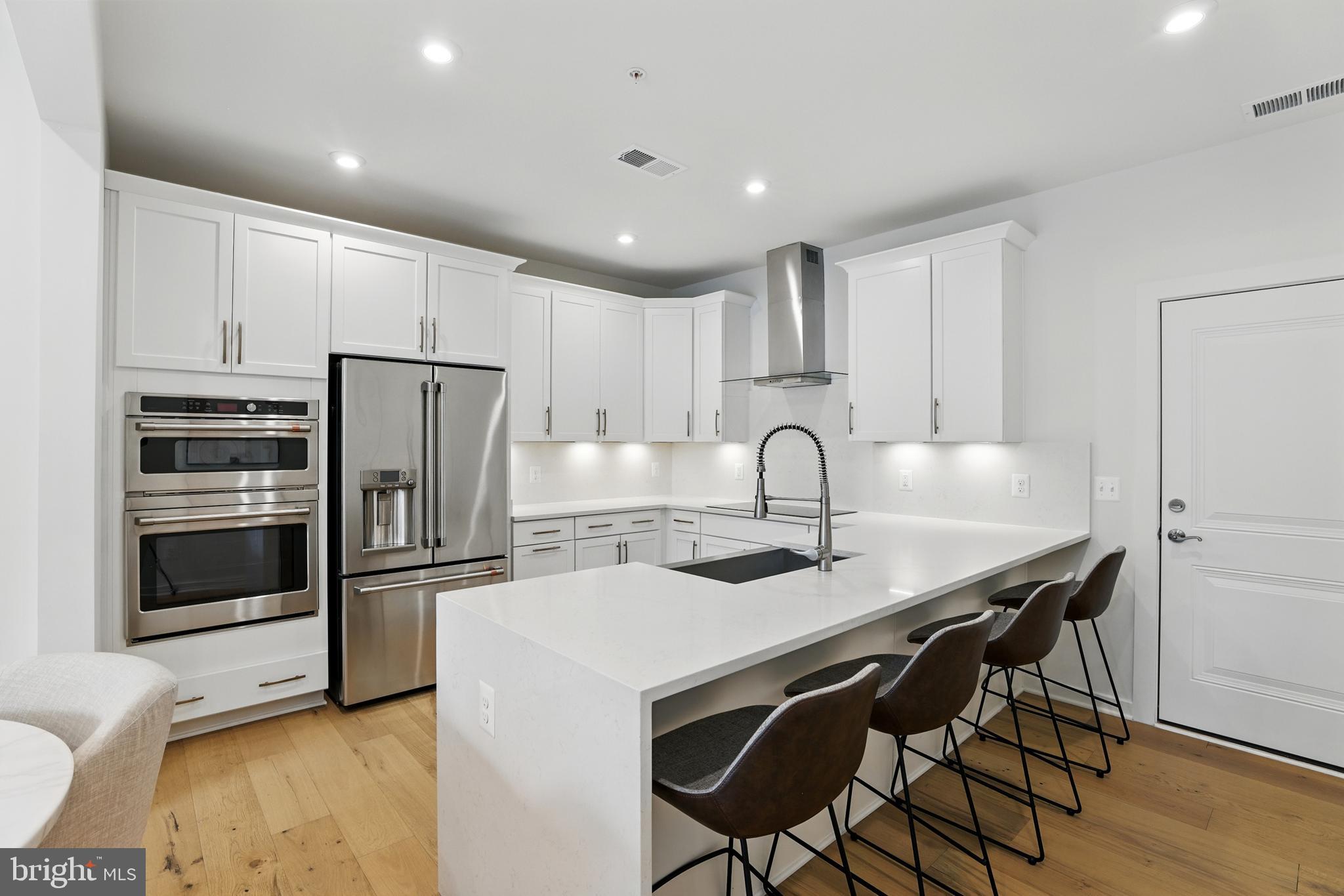 4140 Legato Road, Unit 47 Fairfax, VA 22033 - Photo 8 of 23 a kitchen with stainless steel appliances granite countertop a stove a refrigerator and a microwave