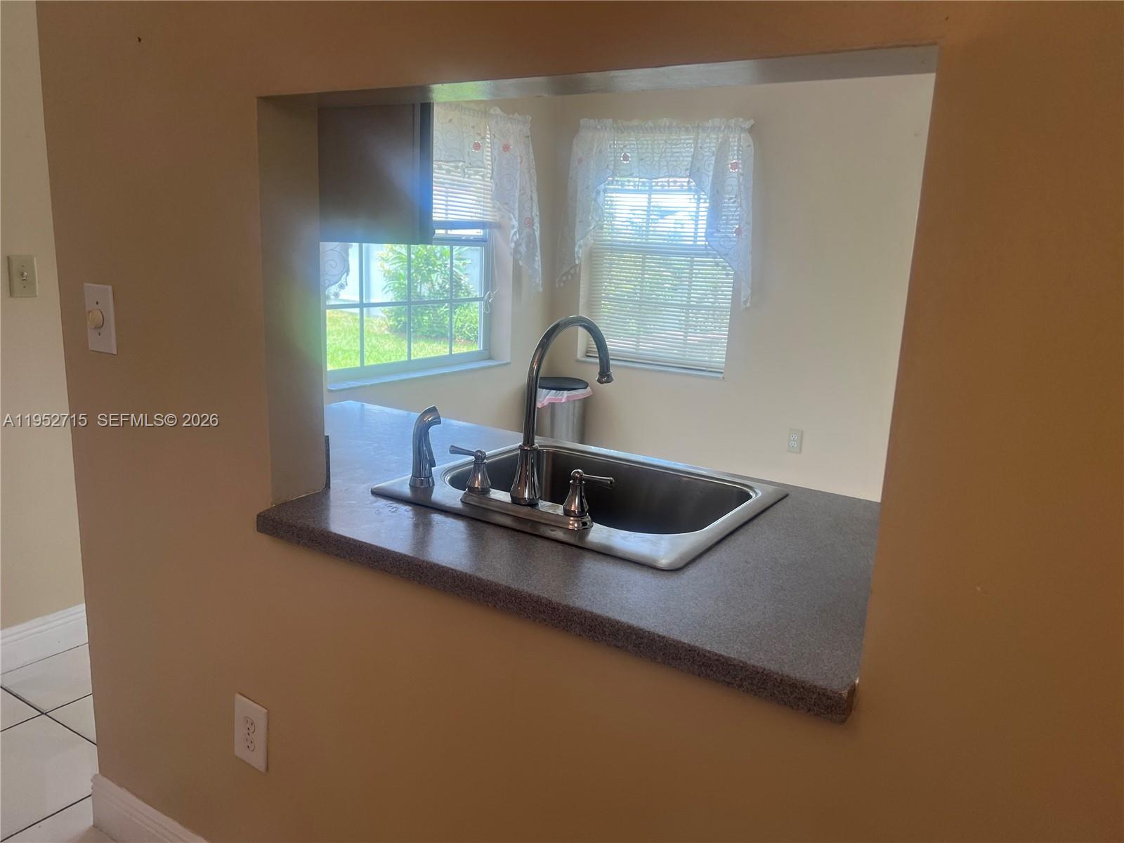 5827 Northwest 197th Terrace Hialeah, FL 33015 - Photo 11 of 30 a view of a kitchen with a sink and a window