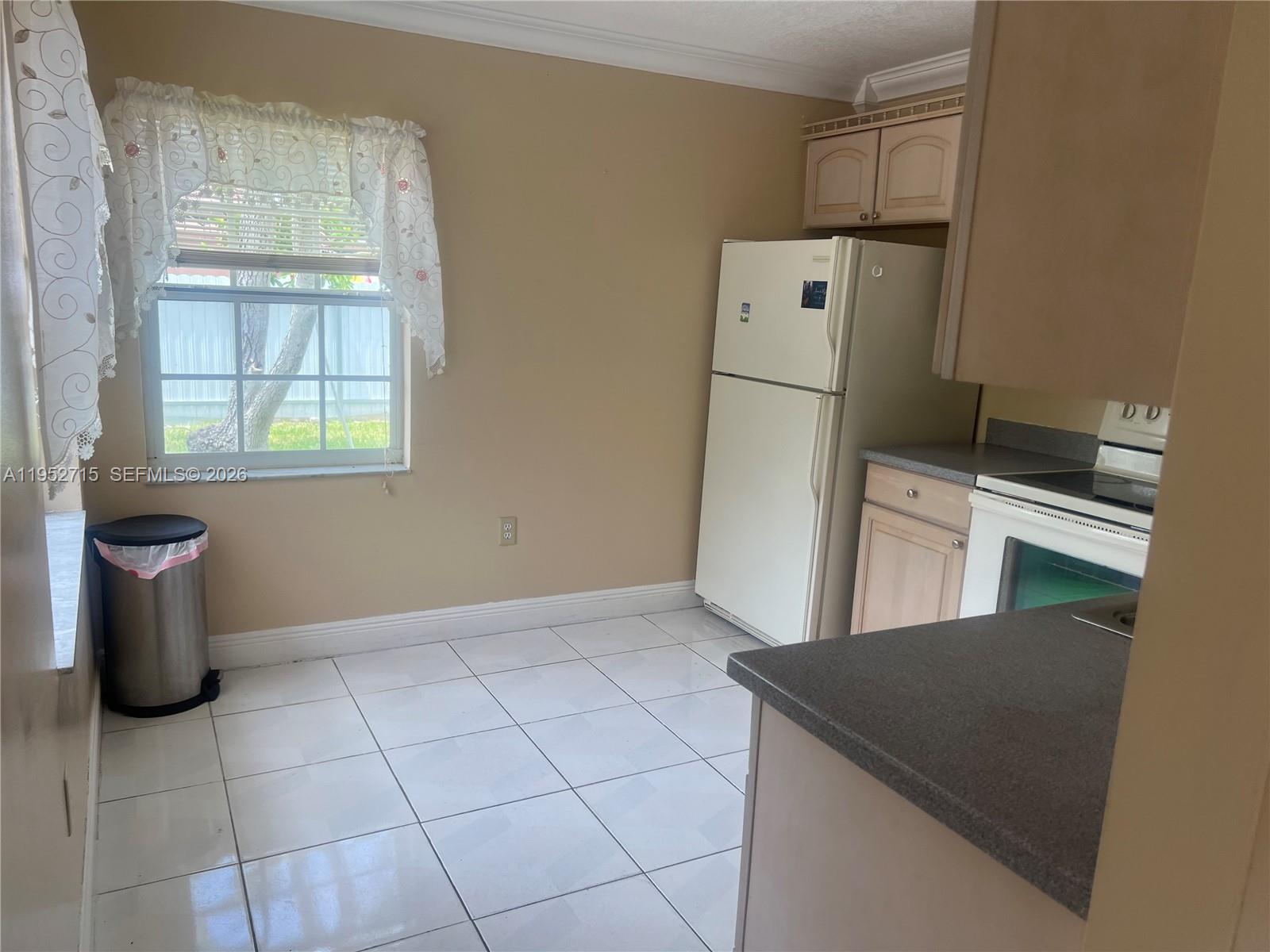 5827 Northwest 197th Terrace Hialeah, FL 33015 - Photo 12 of 30 a kitchen with a refrigerator a washer and dryer