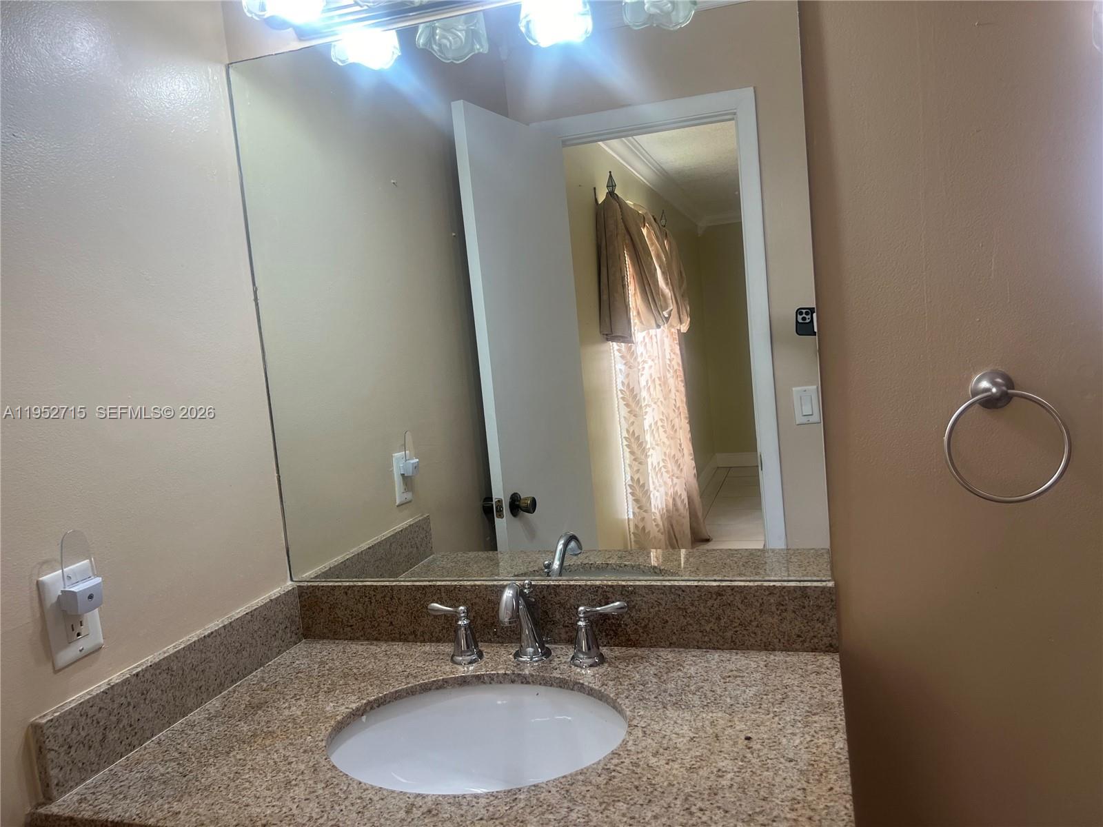 5827 Northwest 197th Terrace Hialeah, FL 33015 - Photo 24 of 30 a bathroom with a granite countertop sink and a mirror