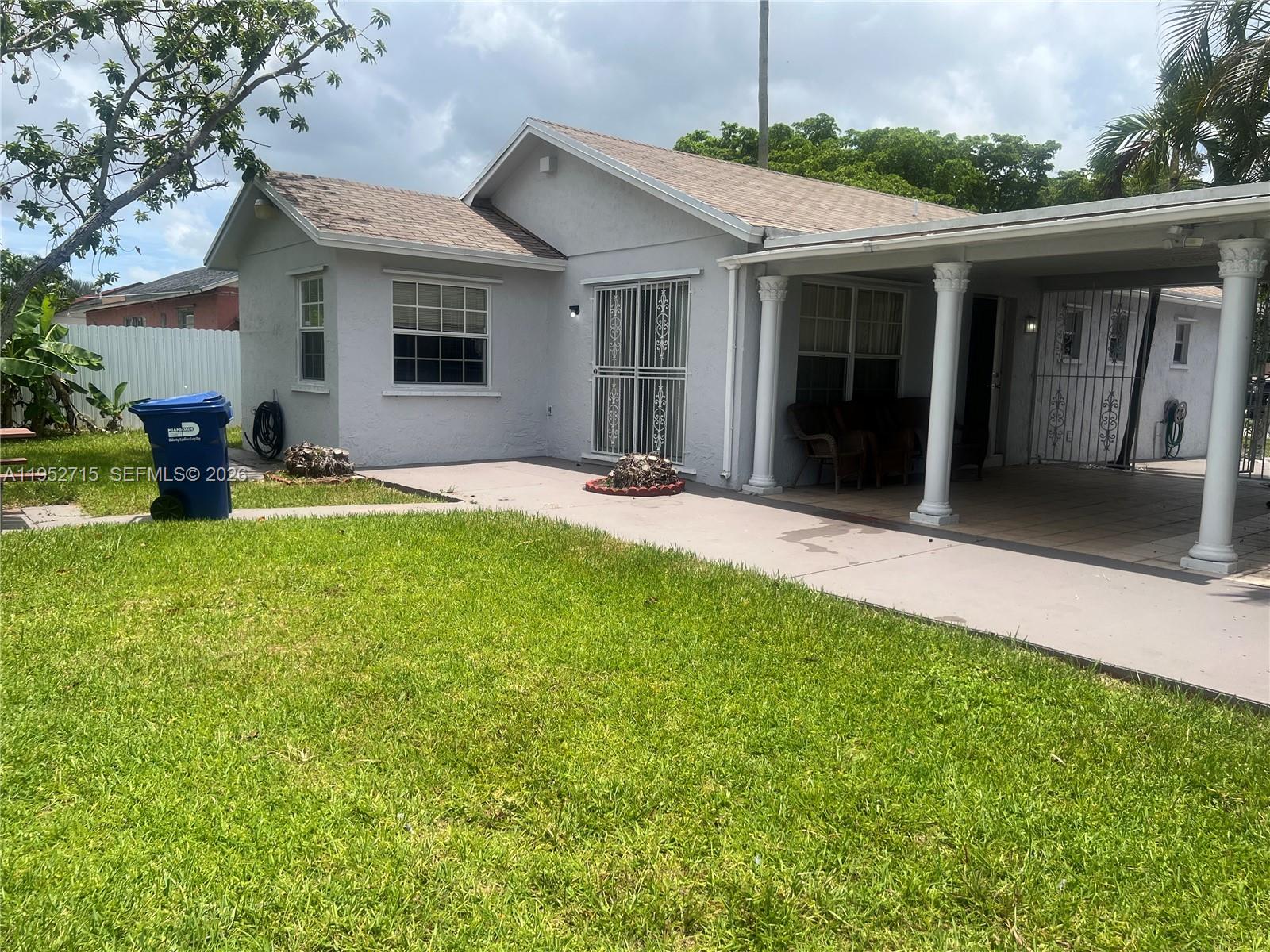 5827 Northwest 197th Terrace Hialeah, FL 33015 - Photo 27 of 30 a front view of a house with yard and green space