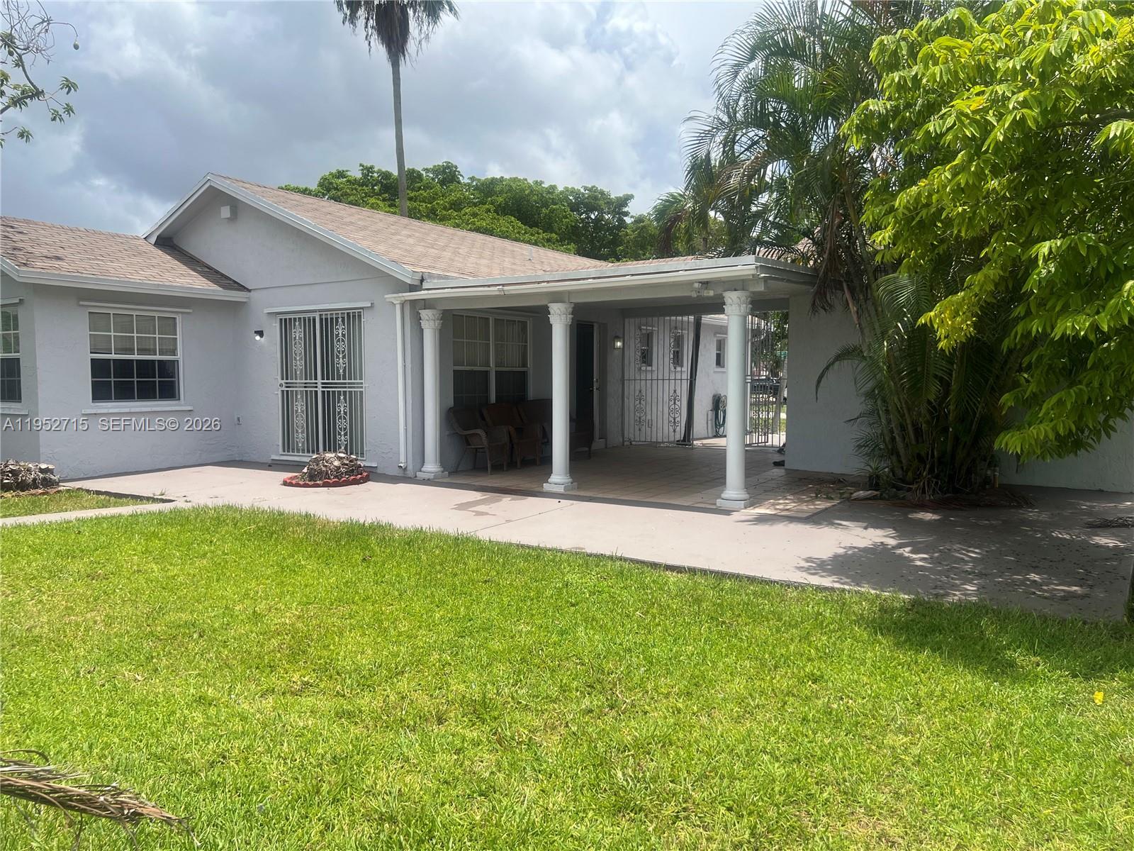5827 Northwest 197th Terrace Hialeah, FL 33015 - Photo 28 of 30 a house view with a garden space