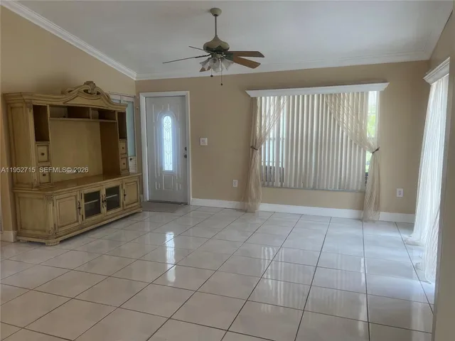 a view of an empty room with a fireplace and a window