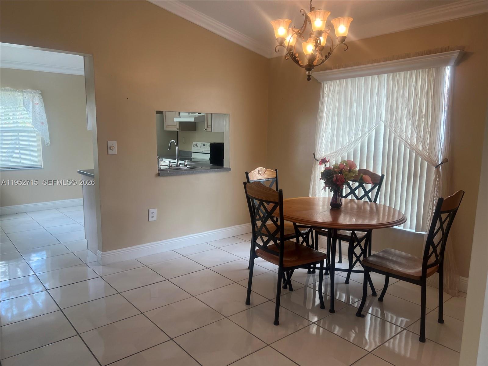 5827 Northwest 197th Terrace Hialeah, FL 33015 - Photo 10 of 30 a view of a dining room with furniture and chandelier