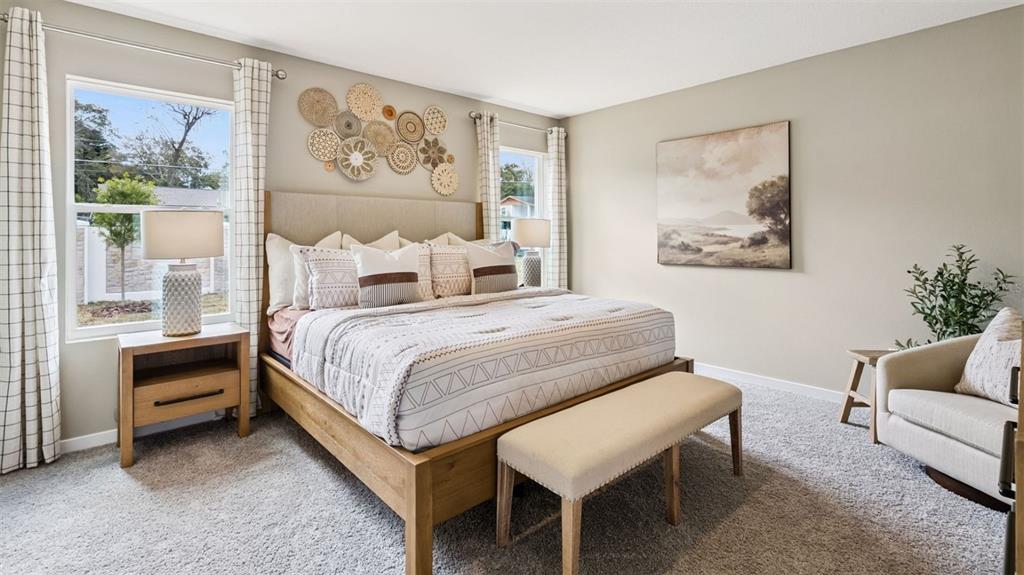 2869 House Finch Road St. Cloud, FL 34773 - Photo 12 of 56 a bedroom with a bed and a painting on the wall