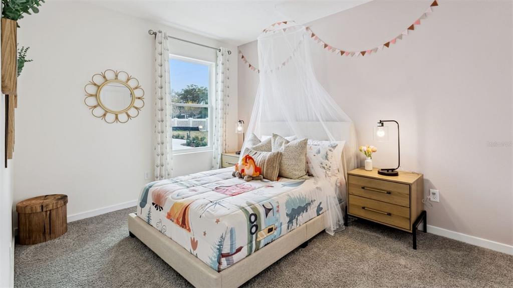 2869 House Finch Road St. Cloud, FL 34773 - Photo 16 of 56 a bedroom with a bed and a window