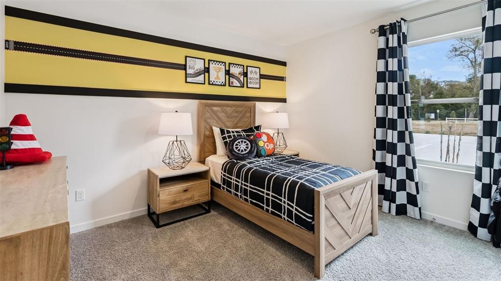 2869 House Finch Road St. Cloud, FL 34773 - Photo 18 of 56 a bedroom with a bed and a window