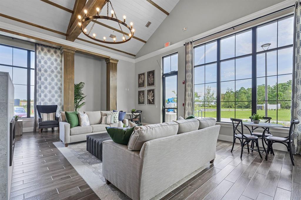 2869 House Finch Road St. Cloud, FL 34773 - Photo 36 of 56 a living room with furniture and floor to ceiling windows