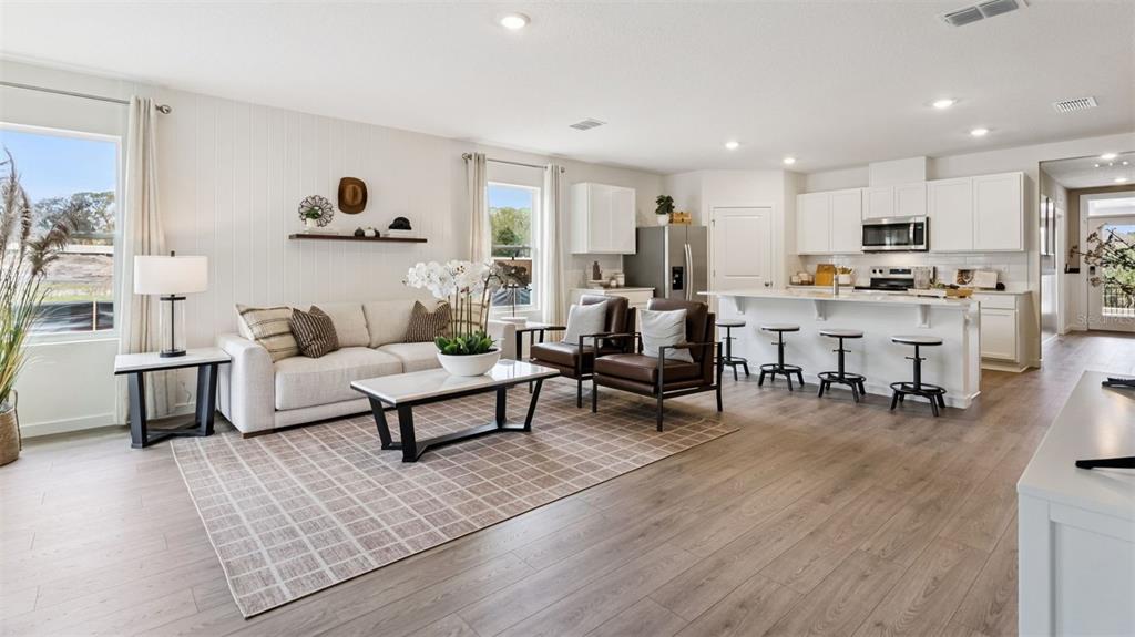 2869 House Finch Road St. Cloud, FL 34773 - Photo 4 of 56 a living room with furniture and a wooden floor