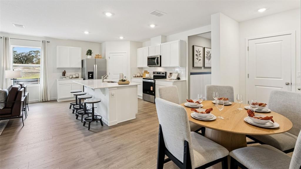 2869 House Finch Road St. Cloud, FL 34773 - Photo 7 of 56 a view of a dining room with furniture and wooden floor