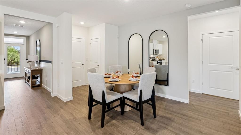 2869 House Finch Road St. Cloud, FL 34773 - Photo 8 of 56 a view of a dining room with furniture and wooden floor