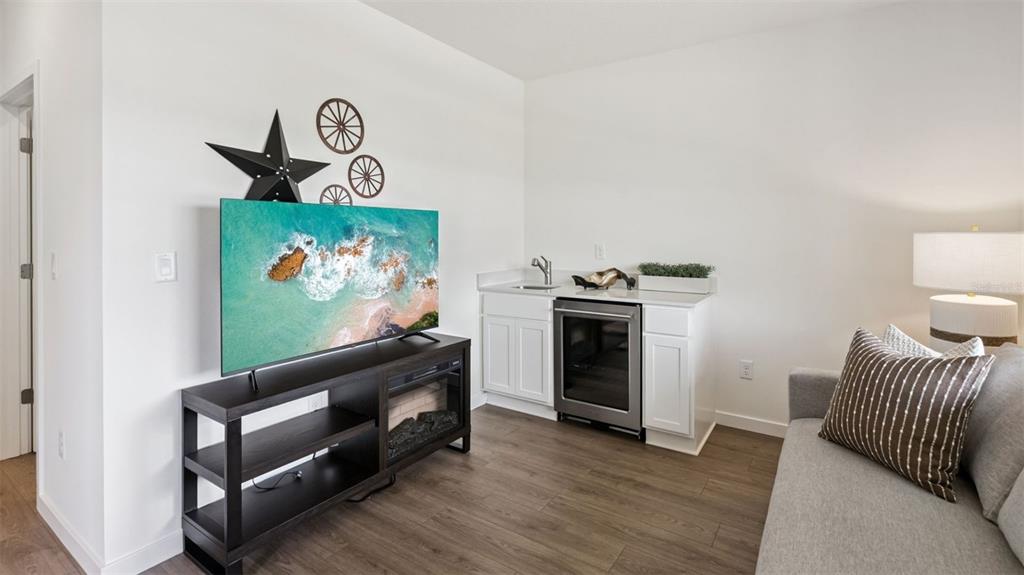 2869 House Finch Road St. Cloud, FL 34773 - Photo 9 of 56 a living room with furniture and a fireplace