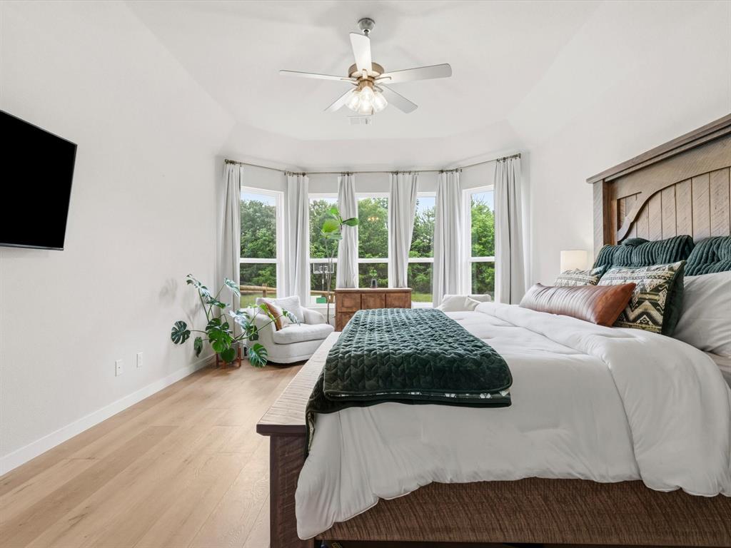 155 Rj Smith Drive Boyd, TX 76023 - Photo 17 of 37 Private primary suite with spacious layout and peaceful views of the surrounding property.