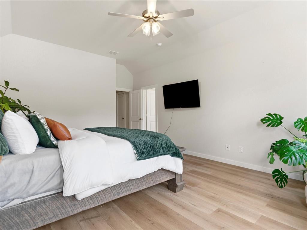 155 Rj Smith Drive Boyd, TX 76023 - Photo 19 of 37 Private primary suite with spacious layout and peaceful views of the surrounding property.