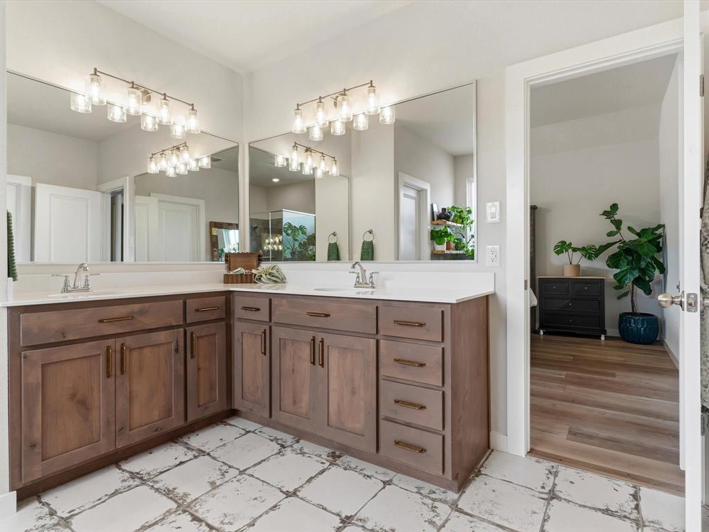 155 Rj Smith Drive Boyd, TX 76023 - Photo 20 of 37 Primary bathroom featuring dual vanities, soaking tub, and separate shower.