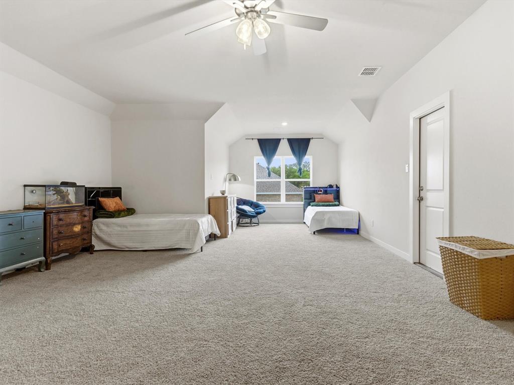 155 Rj Smith Drive Boyd, TX 76023 - Photo 29 of 37 Versatile bonus room upstairs with en-suite bathroom, perfect for large second primary, media room, game room, or additional living space.