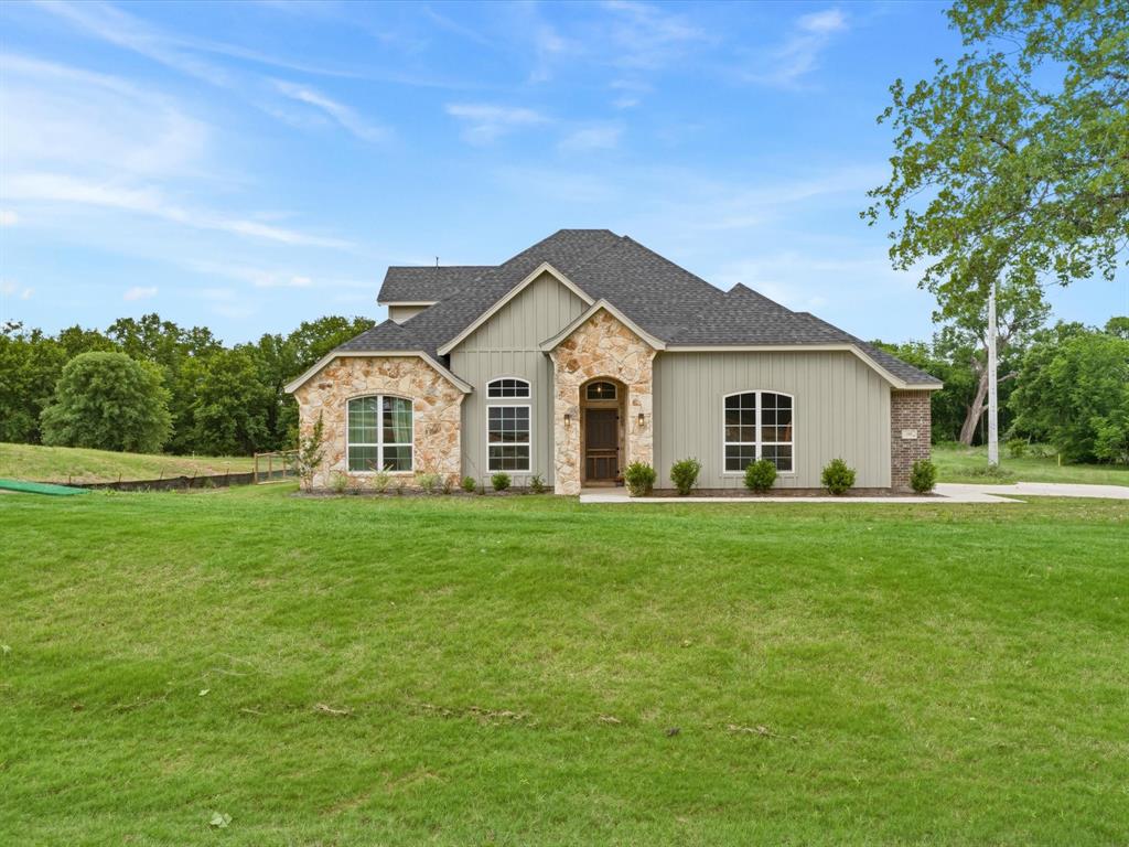 155 Rj Smith Drive Boyd, TX 76023 - Photo 3 of 37 Charming modern farmhouse on 1.76-acre lot with inviting covered front porch and classic curb appeal in Boyd, Texas.