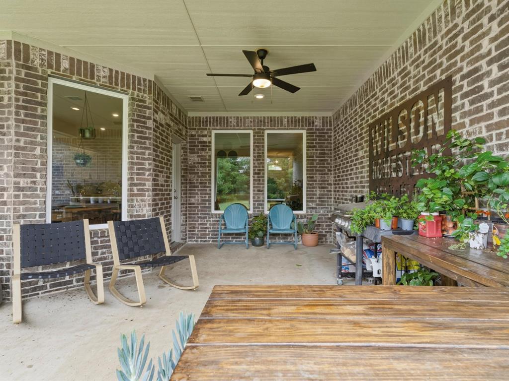 155 Rj Smith Drive Boyd, TX 76023 - Photo 34 of 37 Covered back porch with extended concrete patio, ideal for outdoor dining, relaxing, and entertaining.
