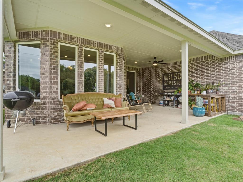 155 Rj Smith Drive Boyd, TX 76023 - Photo 35 of 37 Back patio with extended concrete, offering additional space for outdoor seating and entertaining.