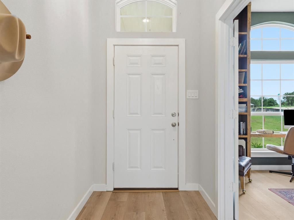 155 Rj Smith Drive Boyd, TX 76023 - Photo 4 of 37 Bright and open entry with natural light, leading into spacious main living areas with farmhouse-style finishes.