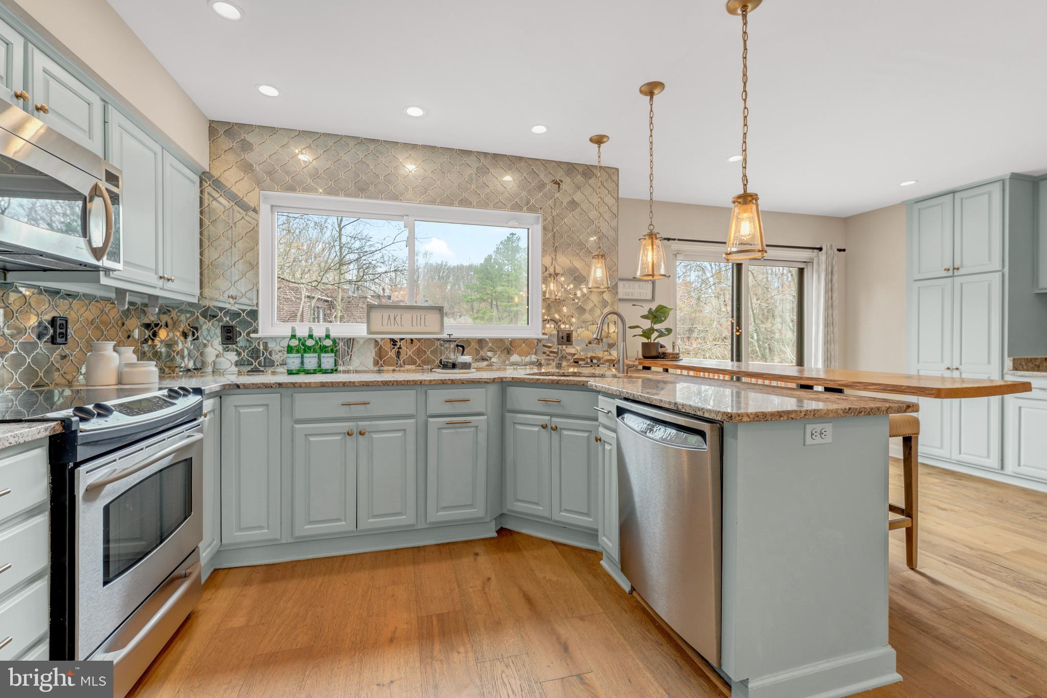2012 Swans Neck Way Reston, VA 20191 - Photo 15 of 48 a kitchen with stainless steel appliances granite countertop a sink a stove a refrigerator cabinets and a kitchen island