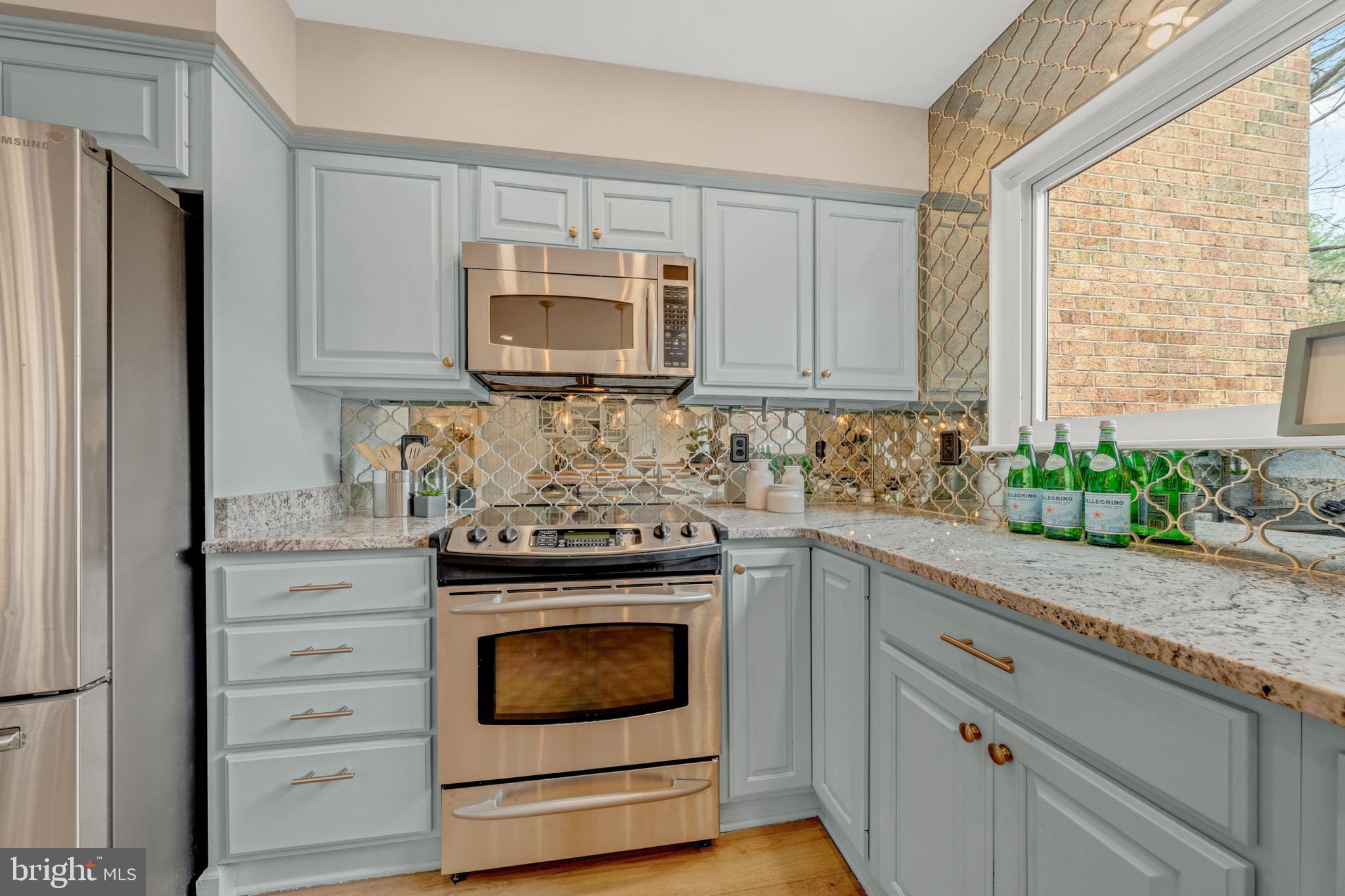2012 Swans Neck Way Reston, VA 20191 - Photo 17 of 48 a kitchen with granite countertop white cabinets and stainless steel appliances