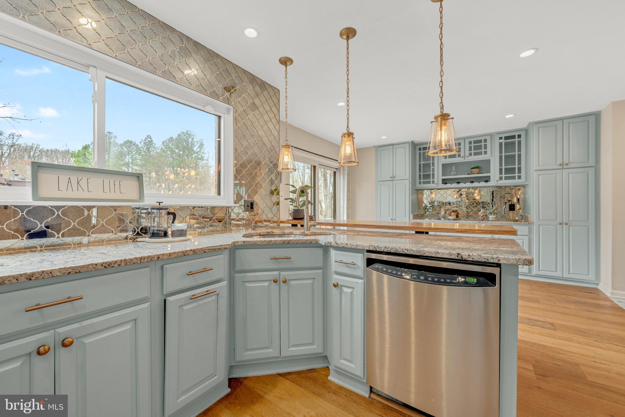 2012 Swans Neck Way Reston, VA 20191 - Photo 18 of 48 a kitchen with stainless steel appliances granite countertop a sink a stove and a wooden floors
