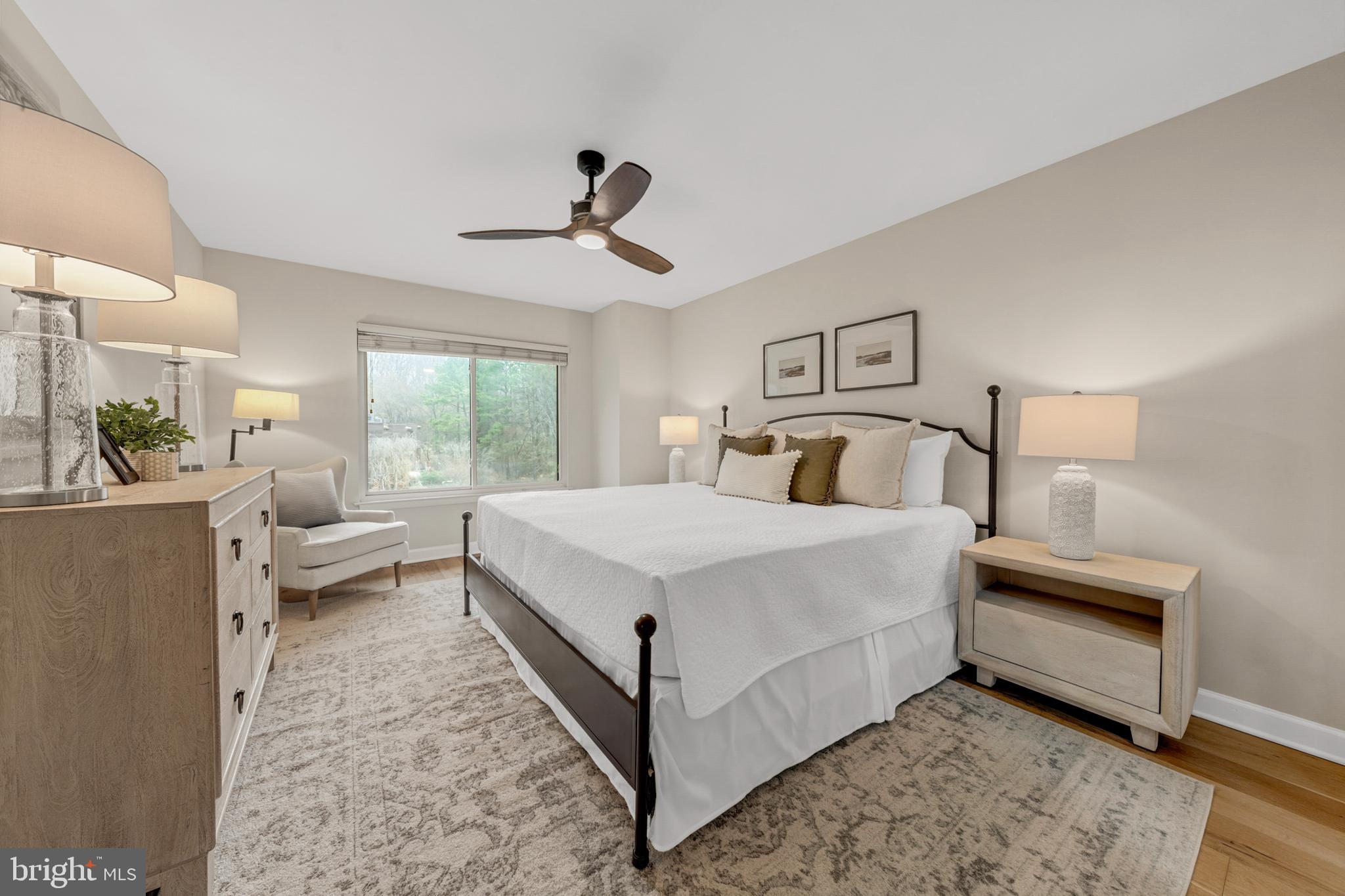 2012 Swans Neck Way Reston, VA 20191 - Photo 23 of 48 a bedroom with a large bed and a chandelier