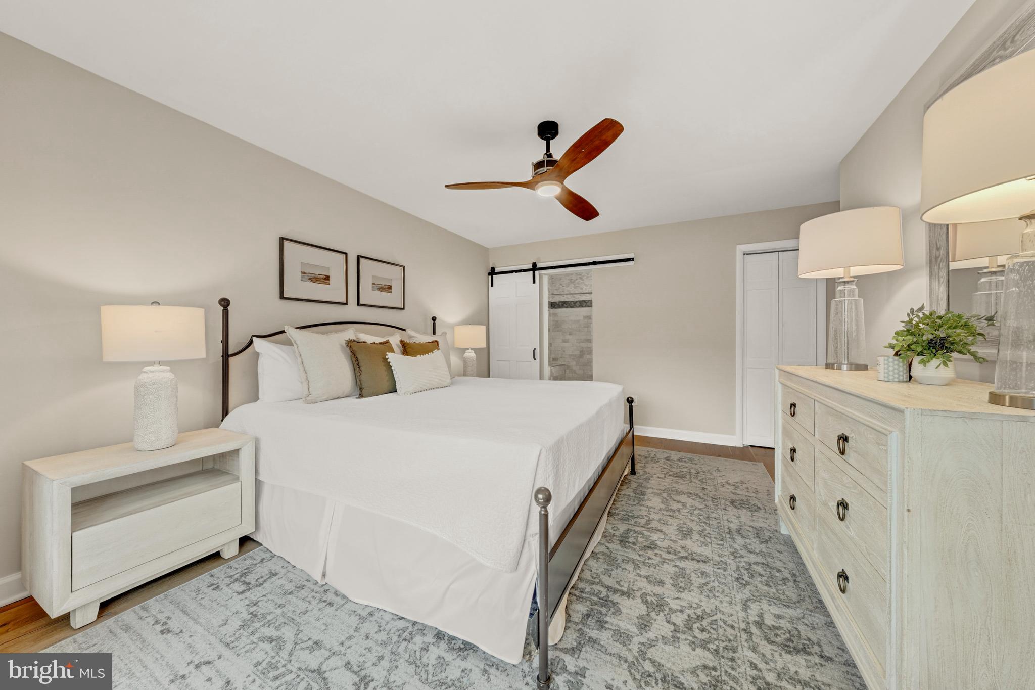 2012 Swans Neck Way Reston, VA 20191 - Photo 24 of 48 a bedroom with a bed and a chandelier