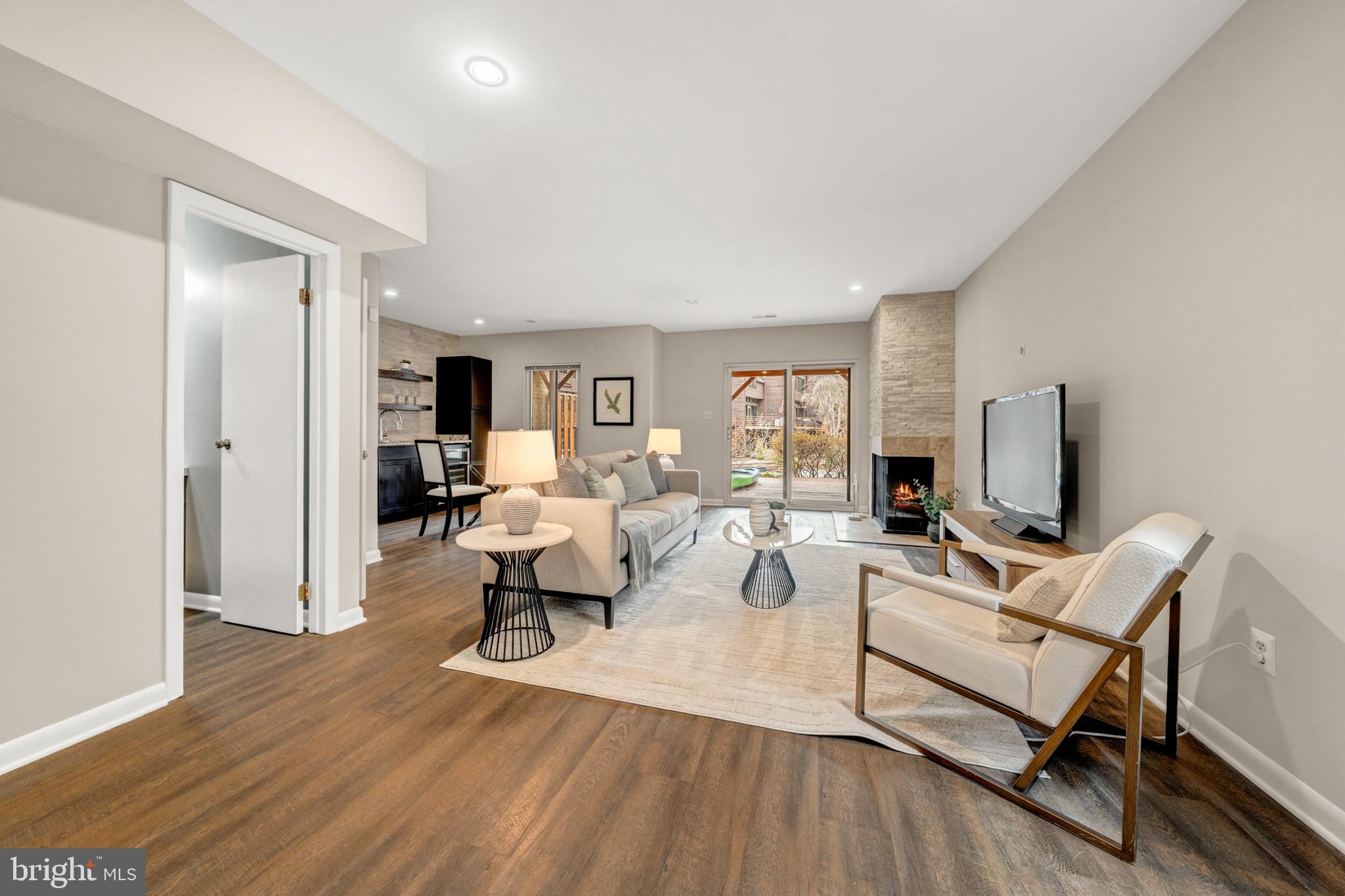 2012 Swans Neck Way Reston, VA 20191 - Photo 31 of 48 a living room with furniture a wooden floor and a flat screen tv
